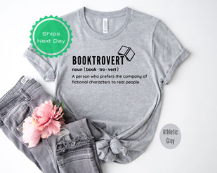 a t - shirt that says booktrover next to a pair of jeans