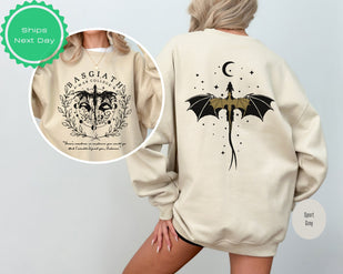 a woman wearing a sweatshirt with a bat on it